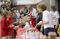 people serving food and ice cream