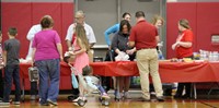 people serving food and ice cream