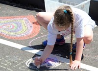 student drawing with chalk