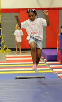 student taking part in gymnastics activity