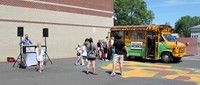 students outdoors with ice cream truck in background