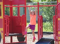 student on monkey bars