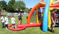 students taking part in inflatable baseball activity