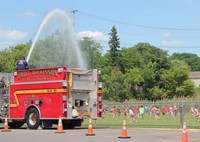 port dickinson fire truck spraying field of students 1