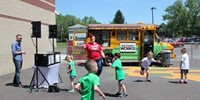 students dancing with ice cream truck in background