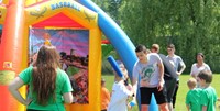 students taking part in inflatable baseball activity