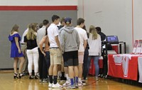 three sport athletes collecting awards