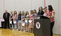 Junior Varsity softball team members and coach