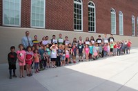 kindergarten and high school students outdoors