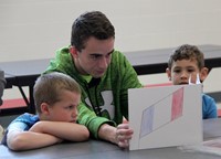 high school student reading to kindergarten students 22