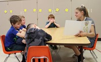 high school student reading to kindergarten students 17