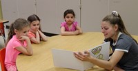 high school student reading to kindergarten students 16