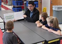 high school student reading to kindergarten students 15