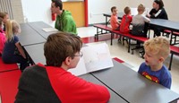 high school students reading to kindergarten students 13