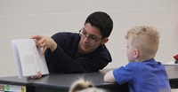 high school student reading to kindergarten students 21