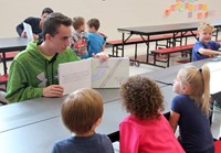 high school student reading to kindergarten students 9