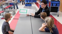 high school student reading to kindergarten students 8