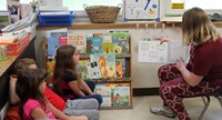 high school student reading to kindergarten students 6