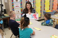 high school student reading to kindergarten students 4