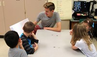 high school student reading to kindergarten students 3