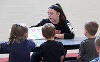 high school student reading to kindergarten students 20