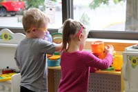 students in play kitchen