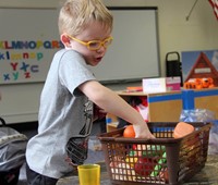 student playing with play food