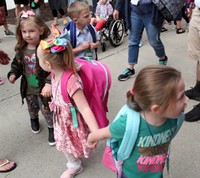 three students holding hands