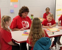 principal and students at kindness station