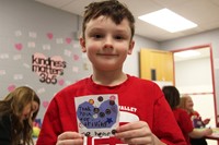 student holding thank you card for bus driver