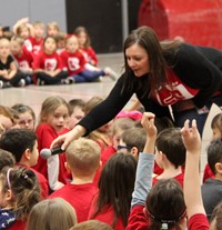 student answering question at morning assembly