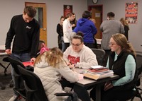 wide shot of high school students and kindness stations