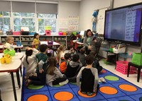 teacher reading to students in classroom