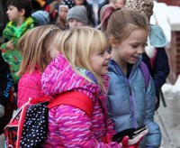 students smiling walking towards school