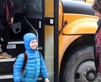 student getting off school bus