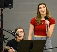 two students singing at big gifted give event