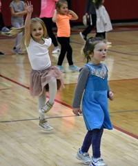 young students dancing at big gifted give