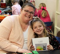 student and adult smiling