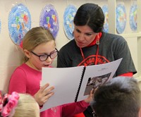 student reading to adult