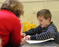 student reading to adult