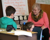 students reading to adult