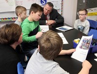 students reading to adults