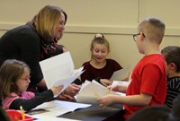 students reading to adult