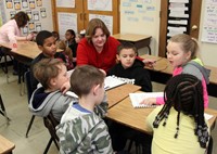 students reading to adults