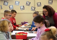 students reading to adult