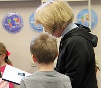 student reading to adult