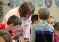 students reading to adult