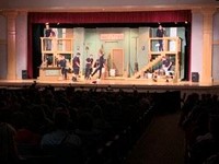 cast members on stage for sneak preview snippet at high school
