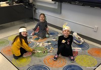 three students taking part in 100th day activities