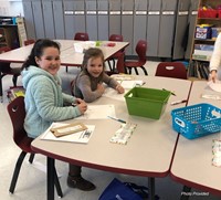 two students smiling taking part in activities